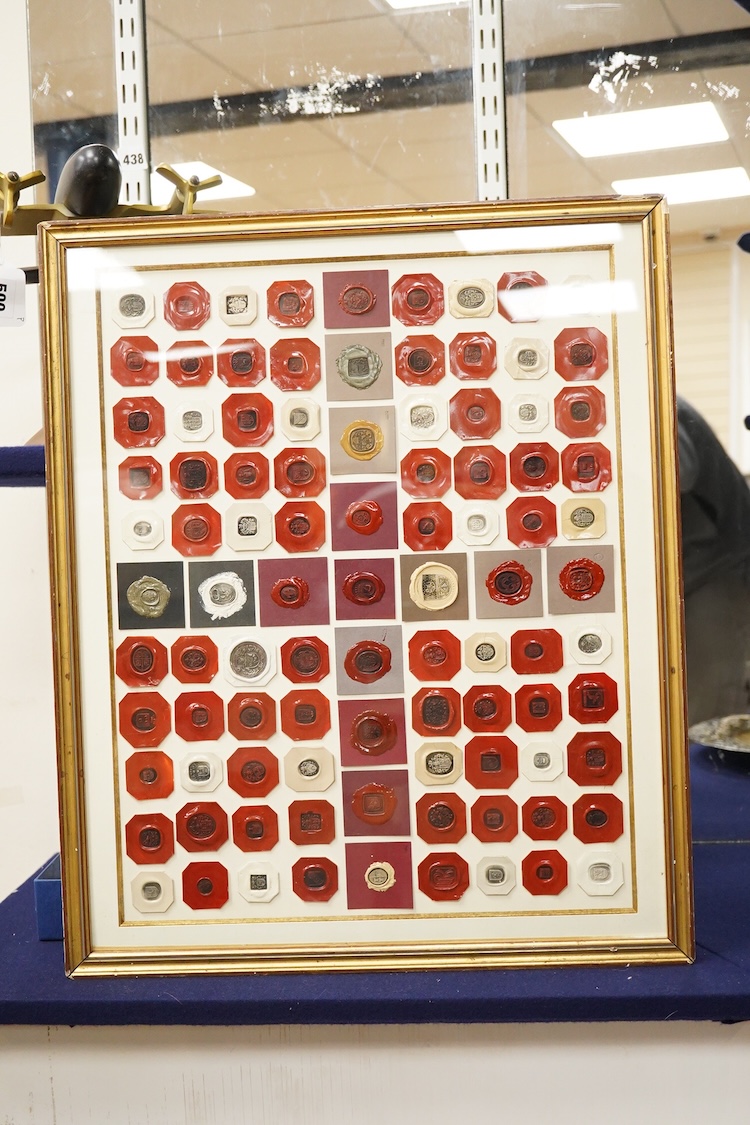 A framed display of red and white wax seals, some stamped Casolo Lausanne, 95 in total, 59cm wide